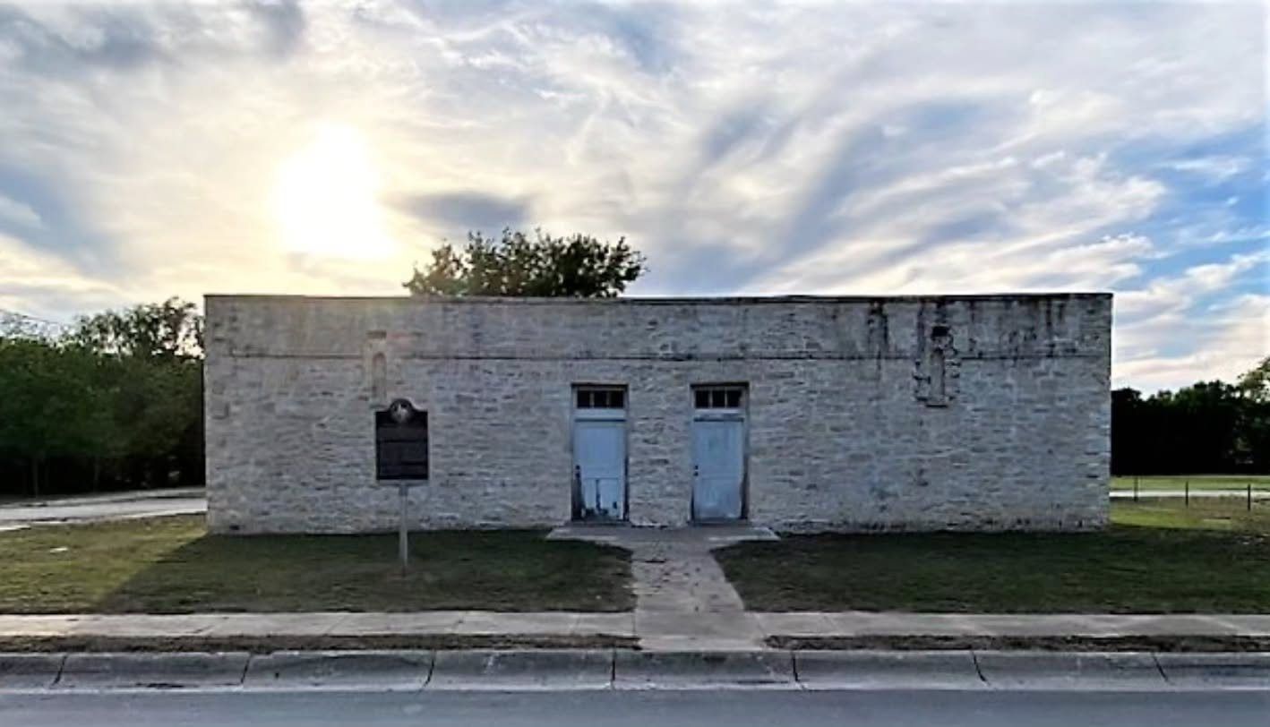 The limestone Lampasas Colored School, 514 College Street, Lampasas, Texas, with its historical marker and two blue doors