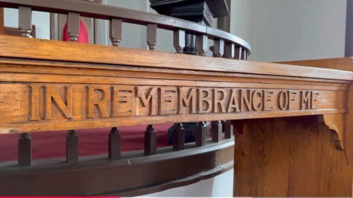 Carved wooden altar rail at New Hope Baptist Church reading In Remembrance of Me